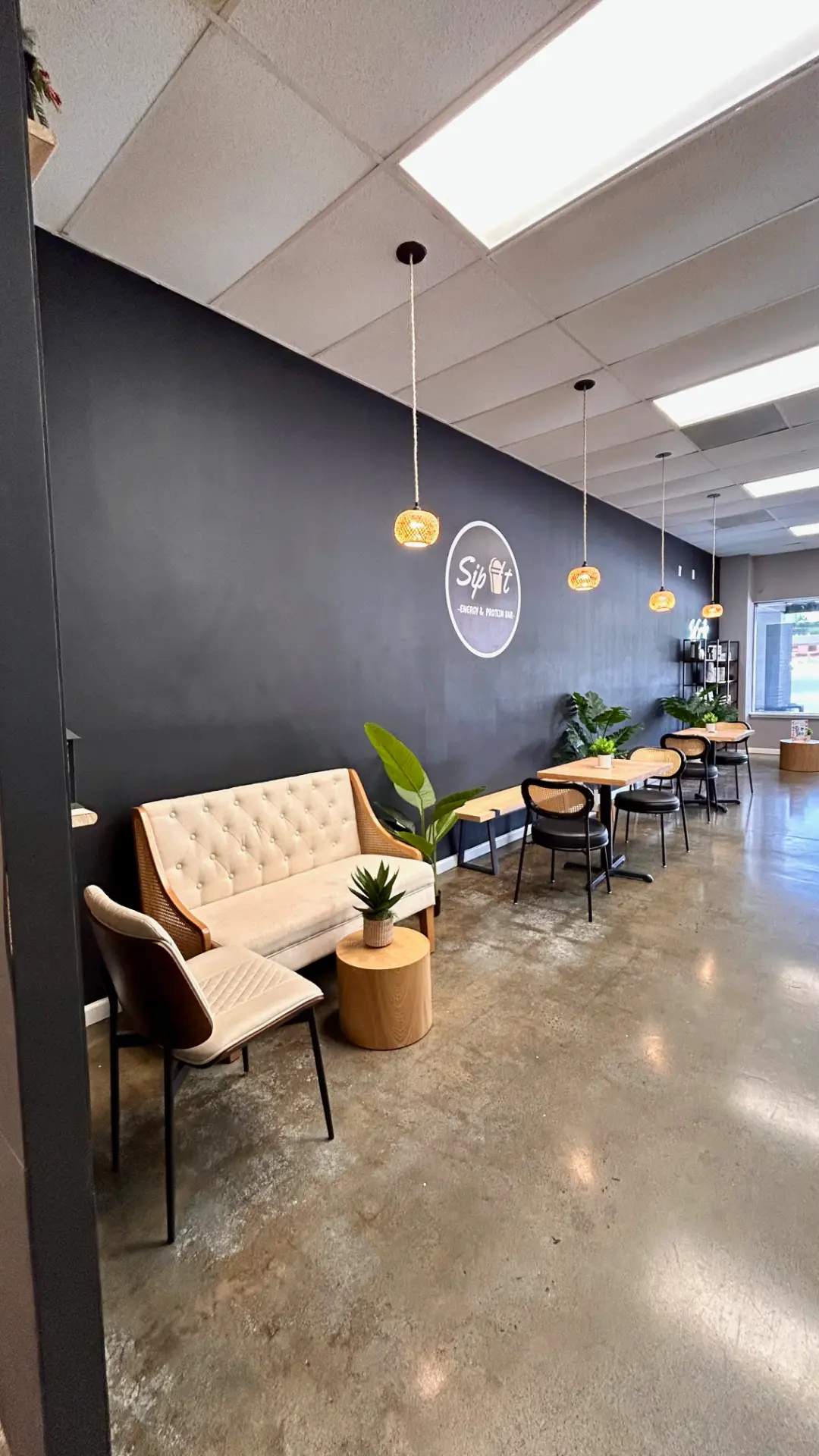 Sip It cafe cozy lounge sofa seating with logo wall