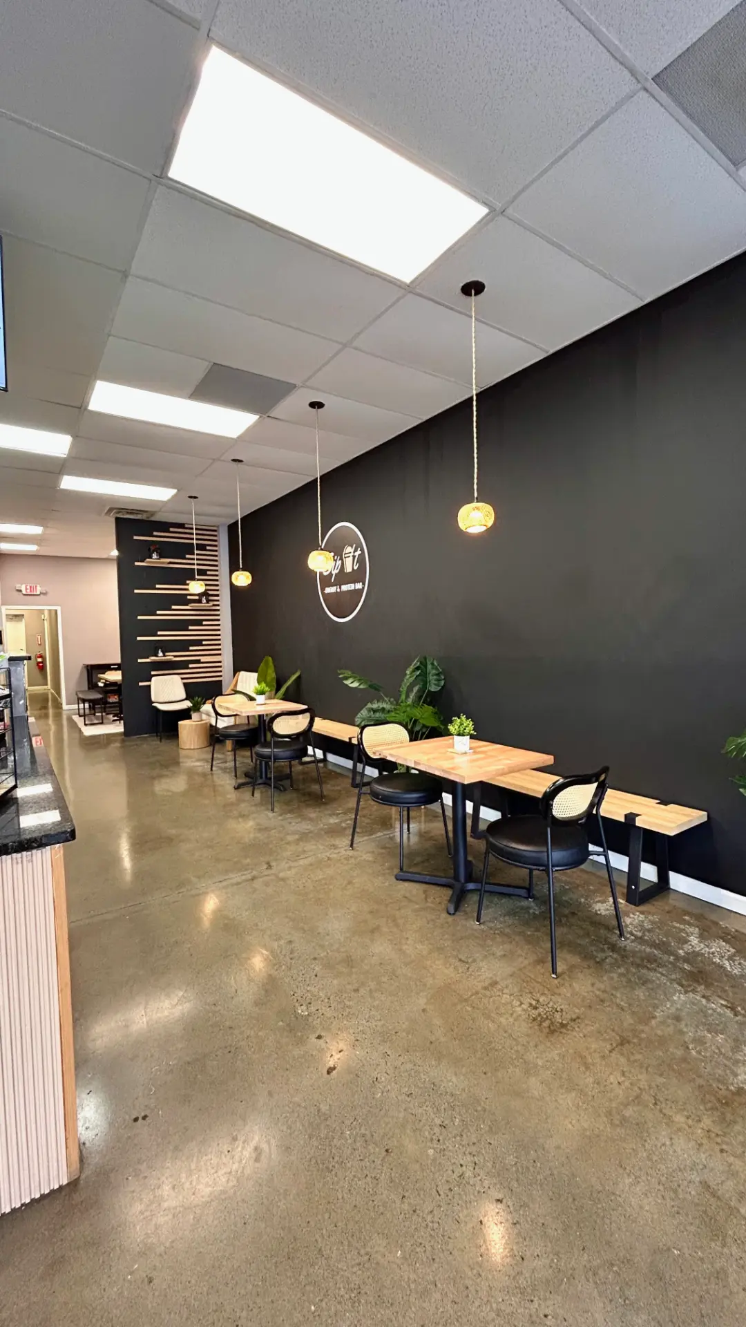Sip It cafe table seating and black accent wall